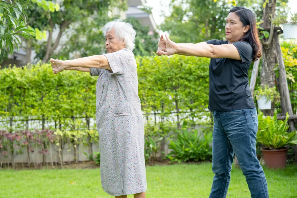 Older woman doing exercise outdoors